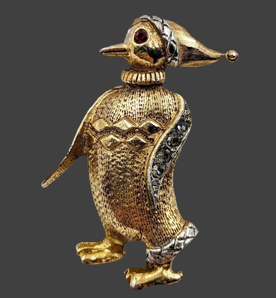 Penguin in a cap and sweater Christmas brooch pin of gold tone, rhinestones. 1960s