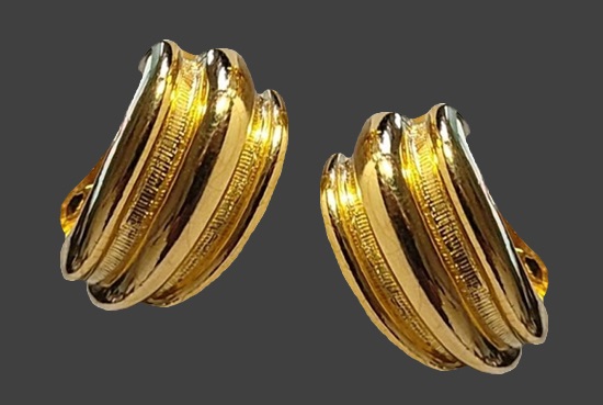 Textured and polished gold tone hoop clip on earrings