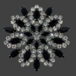 Black accent floral design crystal and rhinestone brooch pin of silver tone. B.David Jewellery Company History