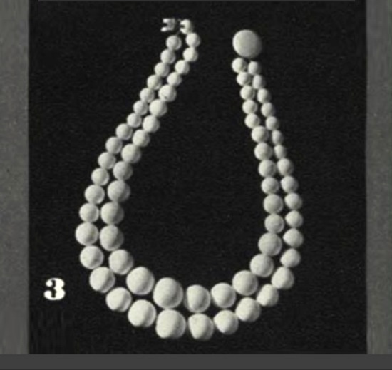 Sculptured beads in chalk white. D. Lisner. Vogue 1937