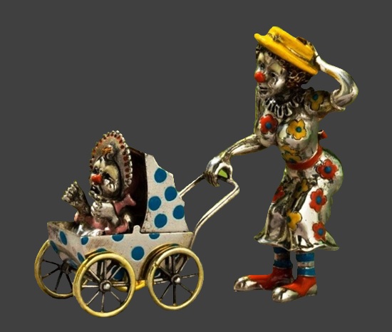 A female clown with a baby in a stroller