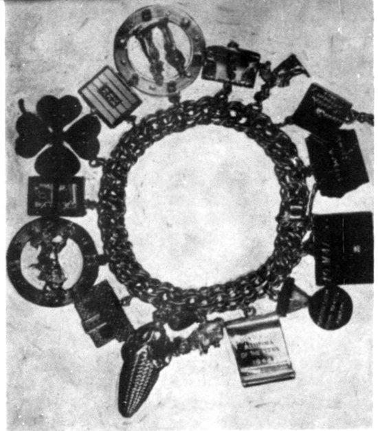 Bracelet with gold charms for the First Lady, Marchal July 1956 ad