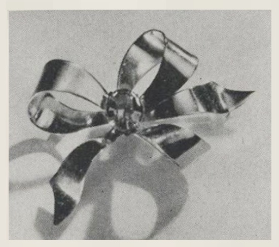 Bright ribbon bow 24 K gold over sterling silver, Vogue February 1943 ad