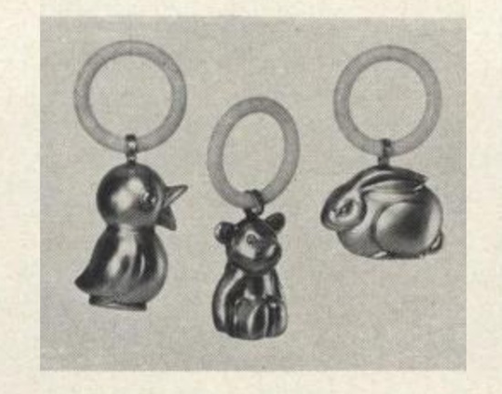 Duck, bear, rabbit, white plastic teething ring carrying a sterling silver animal. From Sweden, $5.95, Vogue June 1957