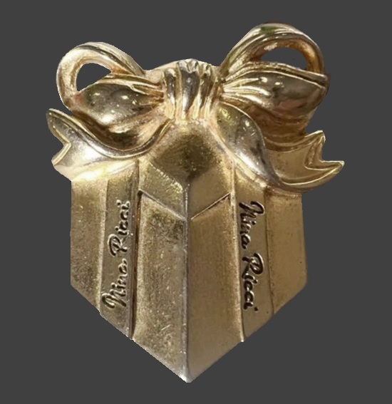 Gift in a box tied with a bow gold tone pin