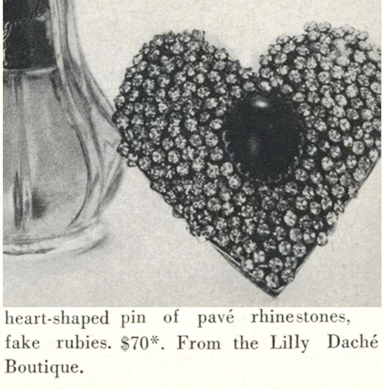 Heart shaped pin of pave rhinestones, fake rubies, Vogue November 1957