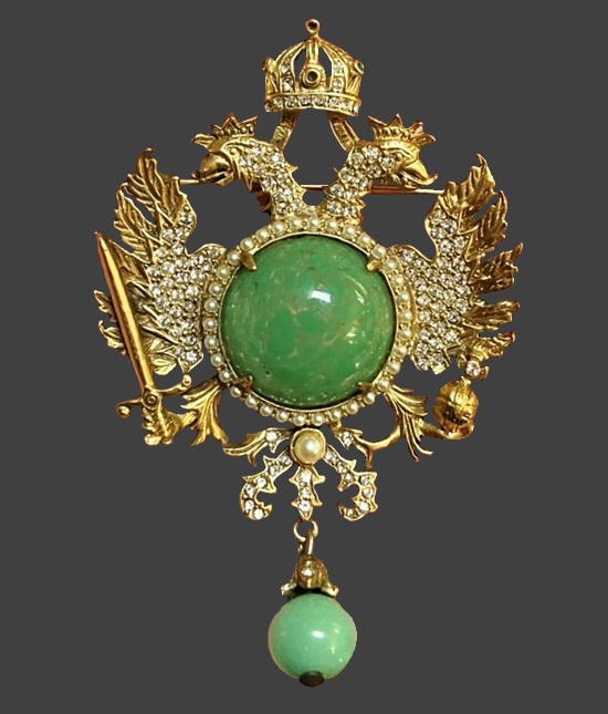 Heraldic brooch in the form of a double-headed eagle with a scepter, orb and crown. Gold tone, green glass, faux pearl