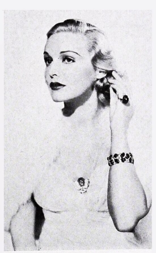 Madeliene Carroll wearing carved sapphire and diamond bracelet, pin and earrings. The Motion Picture Studio Insider, January 1937