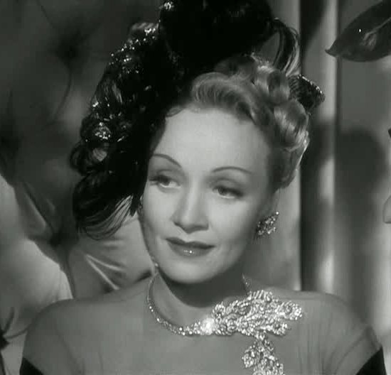 Marlene Dietrich wearing a peacock feather necklace by Paul Flato in The Lady Is Willing, 1942
