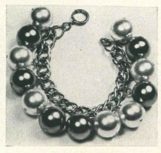 Natural and gunmetal-colored pearls bracelet, Vogue September 1953