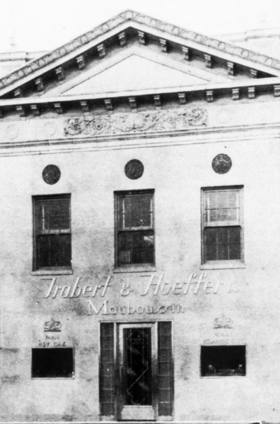 The two story jewelry store of Trabert G Hoeffer, Mauboussin Inc. A white marble facade, invisible windows, a barred grill front door. June 1937