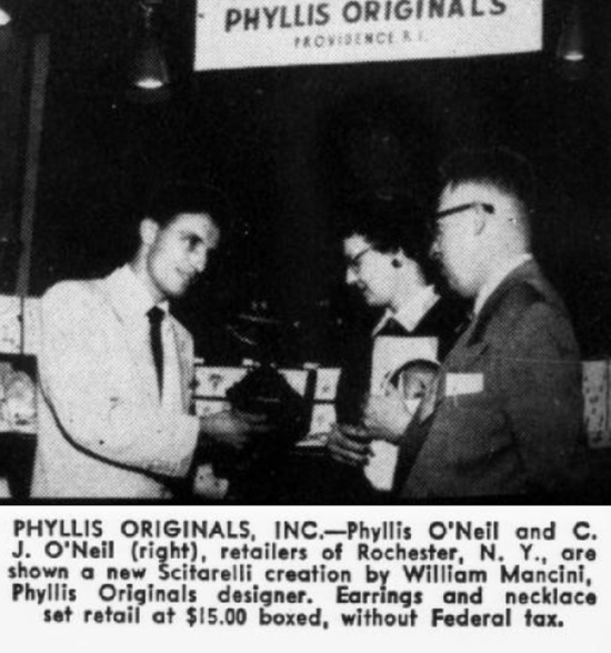 William Mancini, Phyllis Originals designer shows creations by M. & S. Jewelry Mfg to Phyllis O'Neil and C. J. O'Neil (right), retailers of Rochester, N. Y. September 1952 note